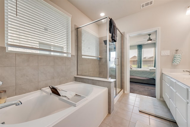 14024 Callisto Way, Haslet, TX 76052 - ensuite bathroom with a bath, tile patterned floors, a shower stall, vanity, and ceiling fan