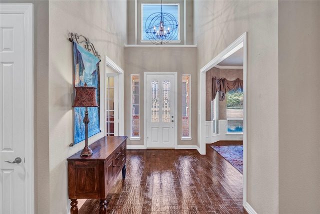 15741 Big Horn Trl, Frisco, TX 75035 - foyer entrance with a towering ceiling, healthy amount of natural light, a chandelier, wood finished floors, and baseboards
