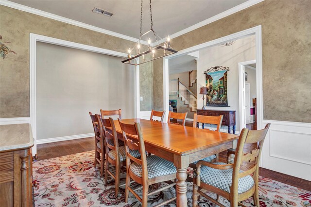 15741 Big Horn Trl, Frisco, TX 75035 - dining space featuring a chandelier, wood finished floors, stairs, and crown molding