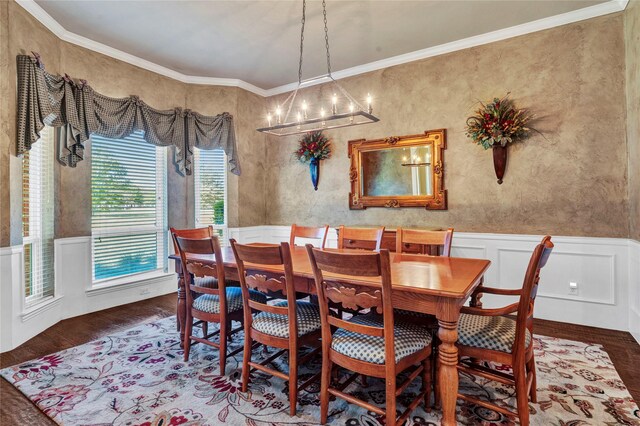15741 Big Horn Trl, Frisco, TX 75035 - dining space with a wainscoted wall, a chandelier, wood finished floors, crown molding, and a decorative wall