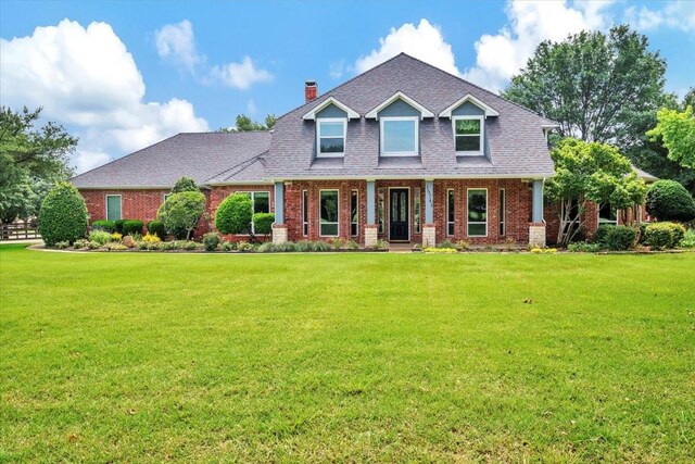 15741 Big Horn Trl, Frisco, TX 75035 - craftsman house with brick siding, covered porch, and a front lawn