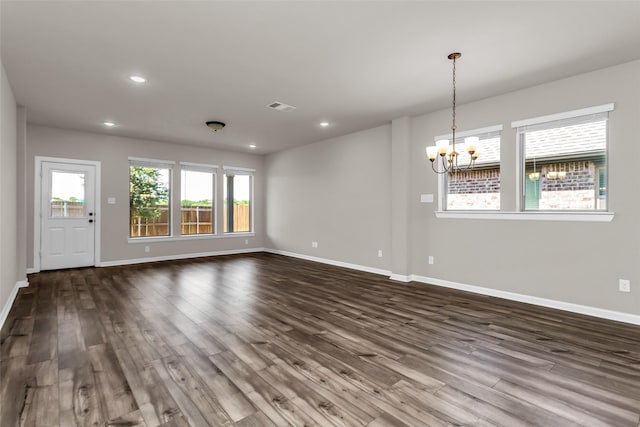 106 Camelia St, Garland, TX 75043 - unfurnished living room featuring a chandelier, dark wood-style flooring, baseboards, and recessed lighting