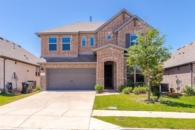 106 Camelia St, Garland, TX 75043 - view of front of property featuring brick siding, a garage, driveway, and a front lawn