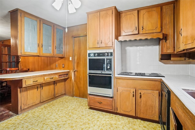 520 Circleview Dr S, Hurst, TX 76054 - kitchen featuring double wall oven, black electric stovetop, a ceiling fan, light countertops, and backsplash