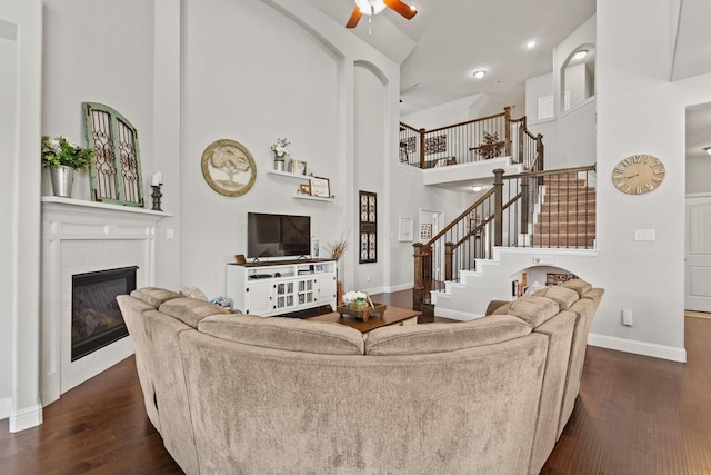 3620 Brahman Ct, Mckinney, TX 75071 - living area with a ceiling fan, stairway, dark wood-style flooring, baseboards, and a high ceiling
