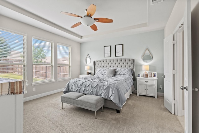 3620 Brahman Ct, Mckinney, TX 75071 - bedroom featuring a tray ceiling, light carpet, baseboards, and a ceiling fan