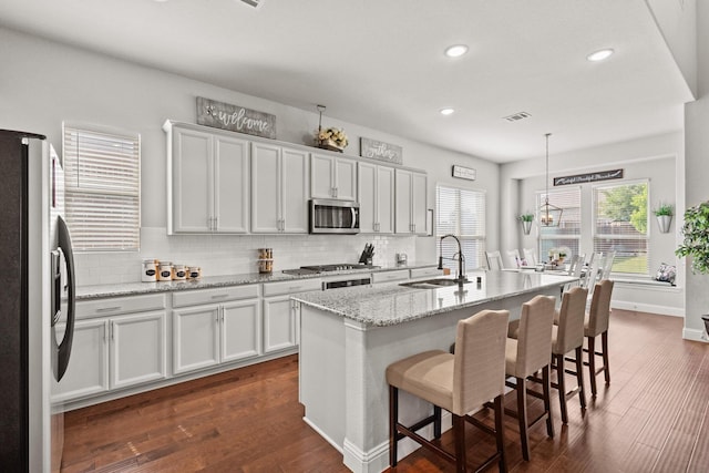3620 Brahman Ct, Mckinney, TX 75071 - kitchen with stainless steel appliances, a sink, backsplash, dark wood-style floors, and recessed lighting