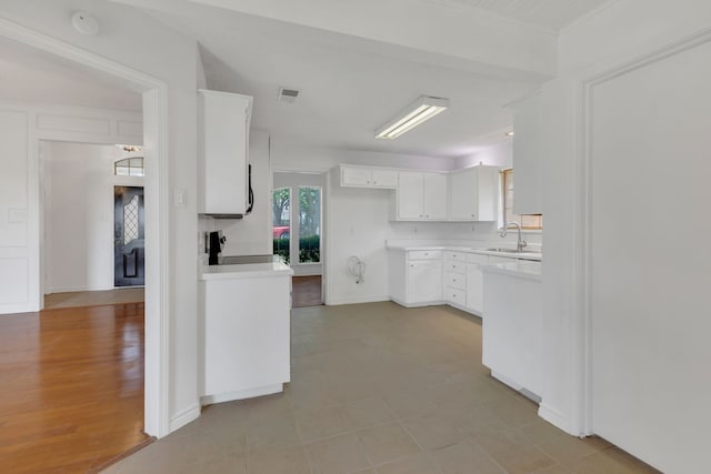 225 Wildwood Dr, Desoto, TX 75115 - kitchen featuring light countertops, white cabinetry, range, baseboards, and a sink