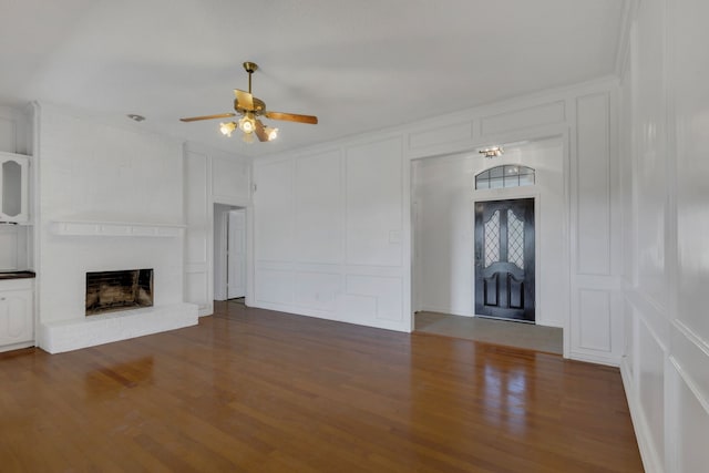 225 Wildwood Dr, Desoto, TX 75115 - unfurnished living room with a decorative wall, a ceiling fan, a fireplace, and wood finished floors
