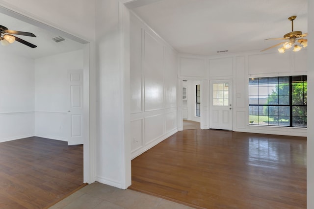225 Wildwood Dr, Desoto, TX 75115 - foyer featuring a ceiling fan, wood finished floors, and a decorative wall