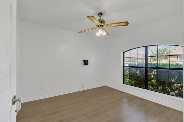 225 Wildwood Dr, Desoto, TX 75115 - unfurnished room featuring light wood-type flooring, plenty of natural light, a ceiling fan, and baseboards