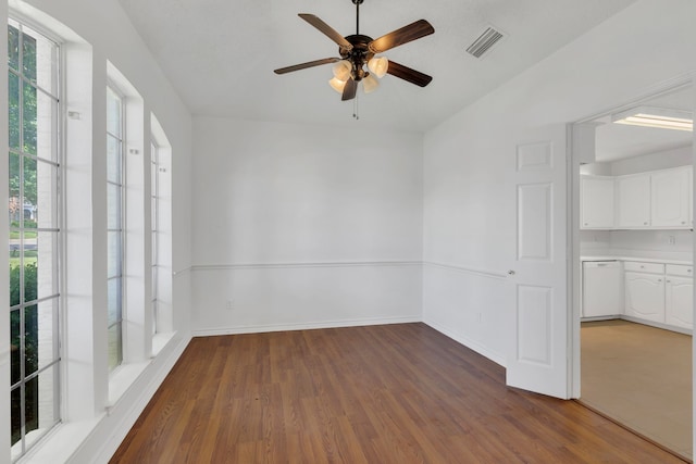 225 Wildwood Dr, Desoto, TX 75115 - empty room with wood finished floors, a ceiling fan, and baseboards
