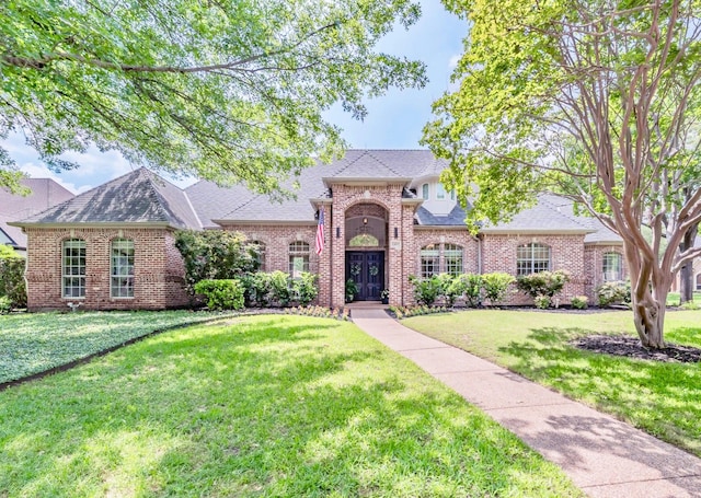 1495 Bent Trail Cir, Southlake, TX 76092 - french country inspired facade featuring a front lawn, brick siding, and roof with shingles