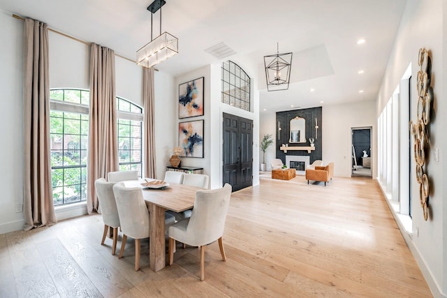 1495 Bent Trail Cir, Southlake, TX 76092 - dining space featuring a chandelier, light wood-type flooring, recessed lighting, a high ceiling, and baseboards