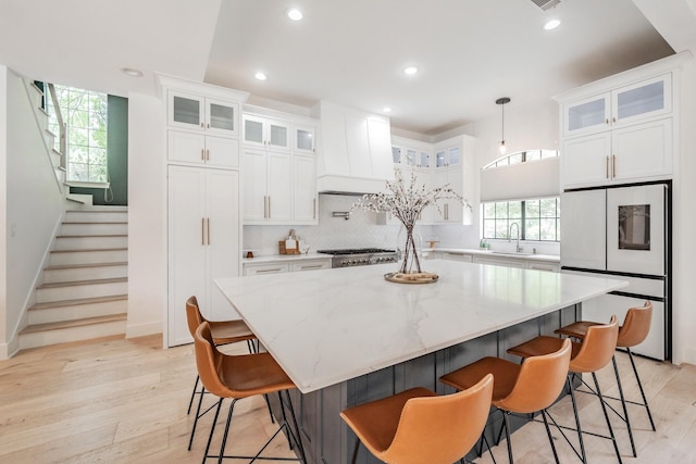 1495 Bent Trail Cir, Southlake, TX 76092 - kitchen featuring fridge, light wood-style floors, white cabinets, and recessed lighting