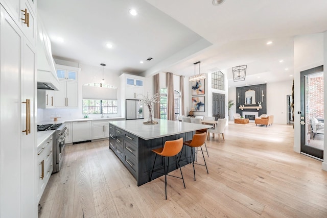 1495 Bent Trail Cir, Southlake, TX 76092 - kitchen featuring high end stainless steel range, white cabinetry, light wood finished floors, light countertops, and glass insert cabinets