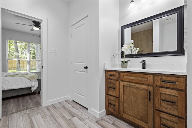 14815 Goliad Dr, Log Cabin, TX 75148 - bathroom featuring vanity, a ceiling fan, baseboards, connected bathroom, and wood finished floors