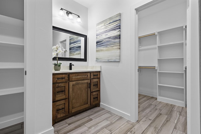 14815 Goliad Dr, Log Cabin, TX 75148 - full bath with a spacious closet, vanity, wood finish floors, and baseboards