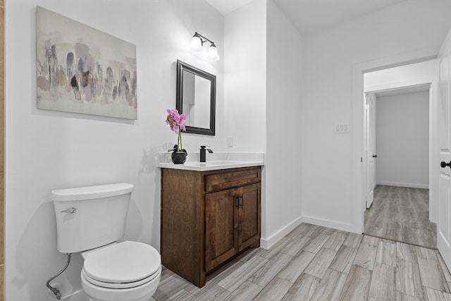 14815 Goliad Dr, Log Cabin, TX 75148 - bathroom with toilet, vanity, wood finished floors, and baseboards