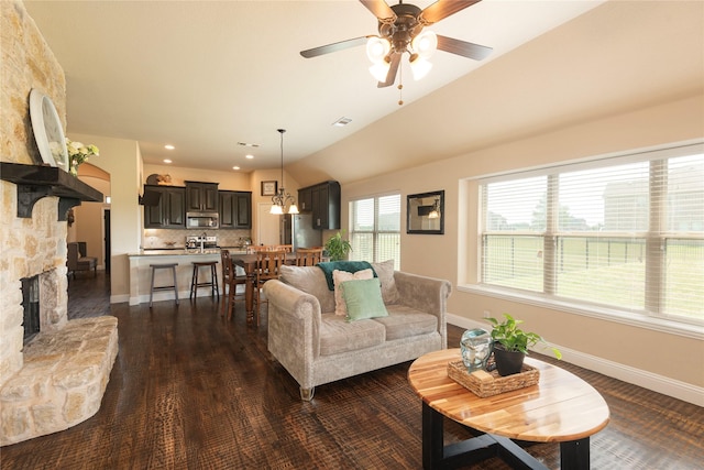703 The Trails Dr, Blue Ridge, TX 75424 - living room with ceiling fan, baseboards, a stone fireplace, dark wood-style floors, and vaulted ceiling