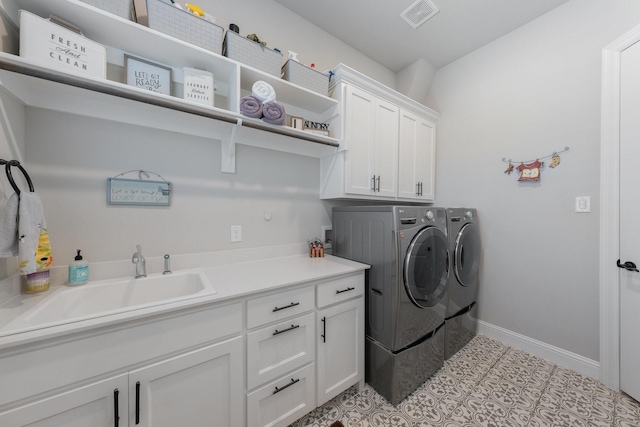 2121 Glenbrook St, Haslet, TX 76052 - laundry room with separate washer and dryer, cabinet space, and baseboards