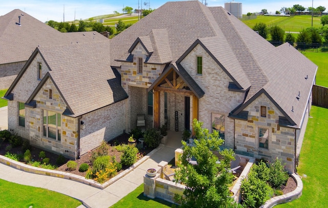 2121 Glenbrook St, Haslet, TX 76052 - french country home with stone siding, roof with shingles, and a front lawn