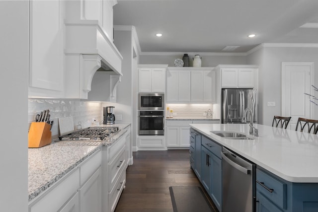 2121 Glenbrook St, Haslet, TX 76052 - kitchen featuring appliances with stainless steel finishes, blue cabinets, a sink, white cabinetry, and ornamental molding