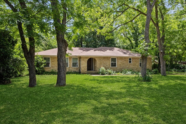 8473 Stults Rd, Dallas, TX 75243 - ranch-style house featuring a front lawn and brick siding
