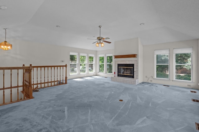 7725 Westwind Dr, Fort Worth, TX 76179 - unfurnished living room featuring carpet, ceiling fan, a chandelier, a tile fireplace, and lofted ceiling