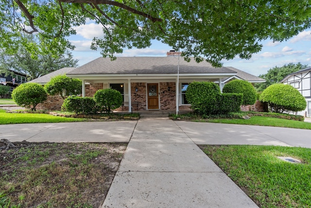 7725 Westwind Dr, Fort Worth, TX 76179 - view of front of property featuring a porch, brick siding, roof with shingles, and a chimney