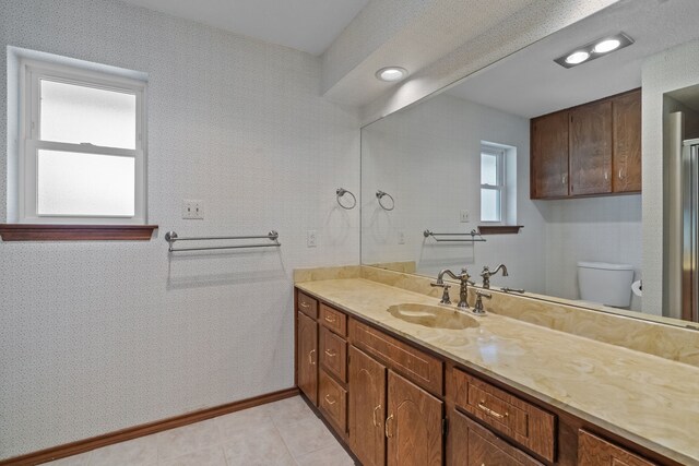 7725 Westwind Dr, Fort Worth, TX 76179 - full bathroom with vanity, toilet, and tile patterned floors