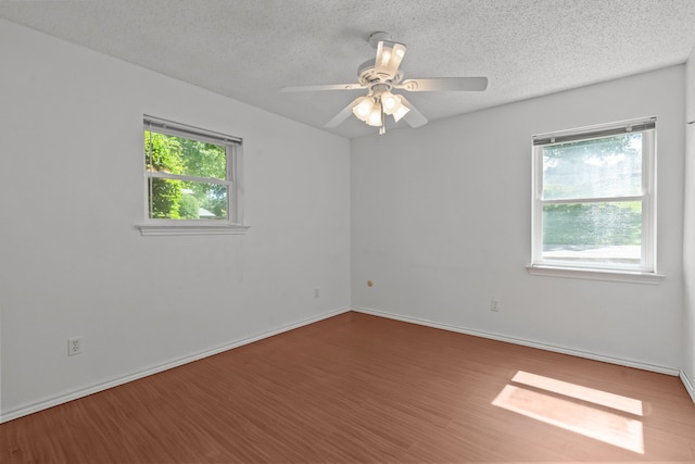 7725 Westwind Dr, Fort Worth, TX 76179 - spare room featuring healthy amount of natural light, wood finished floors, ceiling fan, a textured ceiling, and baseboards