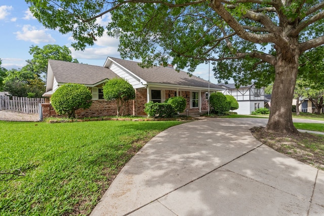 7725 Westwind Dr, Fort Worth, TX 76179 - view of front facade featuring brick siding, roof with shingles, and curved driveway