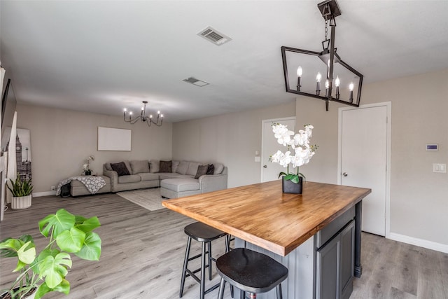 2308 Pheasant Run, Melissa, TX 75454 - dining space featuring a chandelier, light wood finished floors, and baseboards