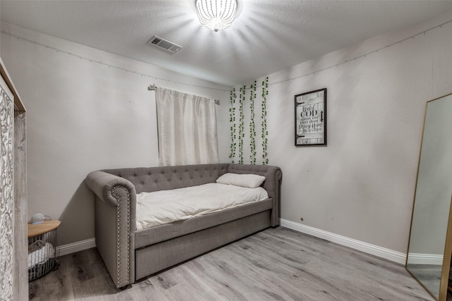 2308 Pheasant Run, Melissa, TX 75454 - bedroom featuring wood finished floors, baseboards, and a textured ceiling