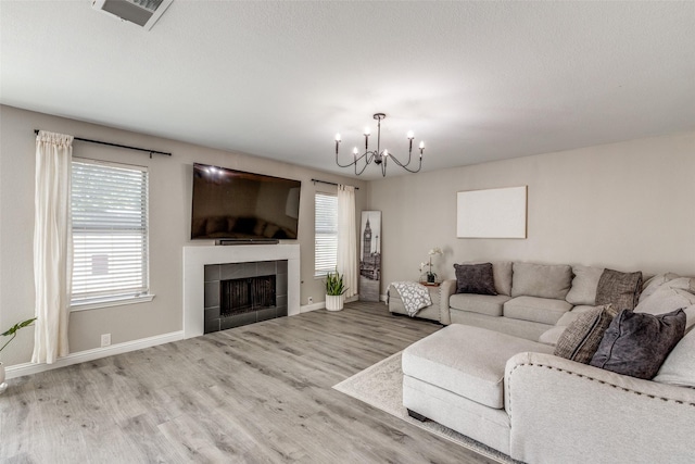 2308 Pheasant Run, Melissa, TX 75454 - living room featuring a chandelier, wood finished floors, healthy amount of natural light, and baseboards