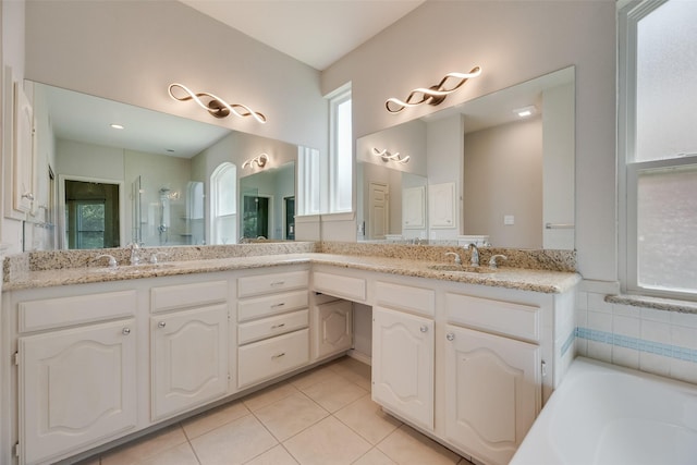3208 Greenglen Dr, Carrollton, TX 75007 - bathroom with tile patterned floors, double vanity, a bath, and a shower