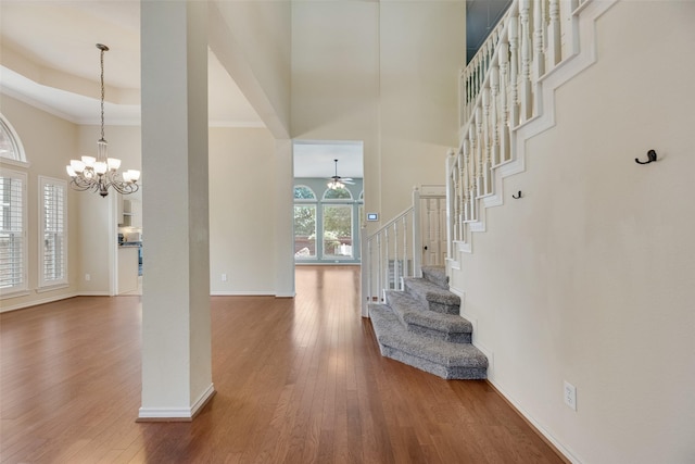 3208 Greenglen Dr, Carrollton, TX 75007 - entryway with a high ceiling, a chandelier, stairway, wood finished floors, and baseboards