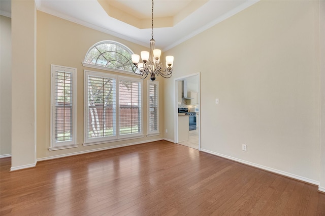 3208 Greenglen Dr, Carrollton, TX 75007 - unfurnished room with wood finished floors, a raised ceiling, a chandelier, baseboards, and crown molding