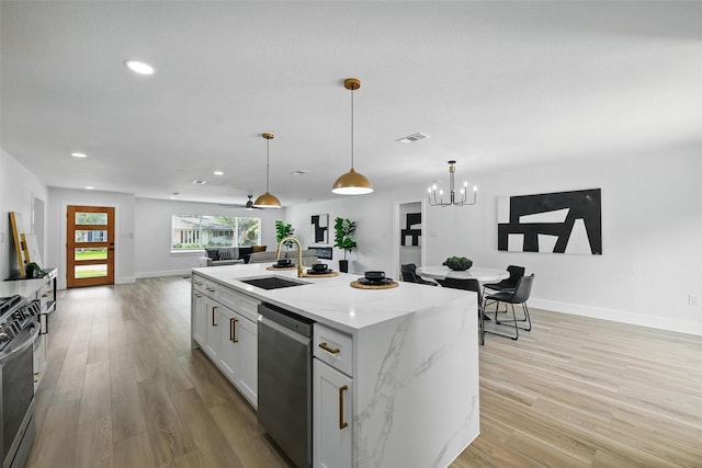 3173 Catamore Ln, Dallas, TX 75229 - kitchen with appliances with stainless steel finishes, a sink, recessed lighting, light wood-style floors, and pendant lighting