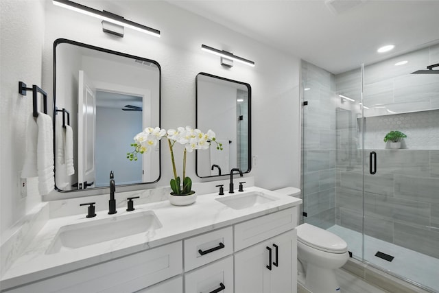 3173 Catamore Ln, Dallas, TX 75229 - bathroom with toilet, double vanity, a stall shower, and recessed lighting