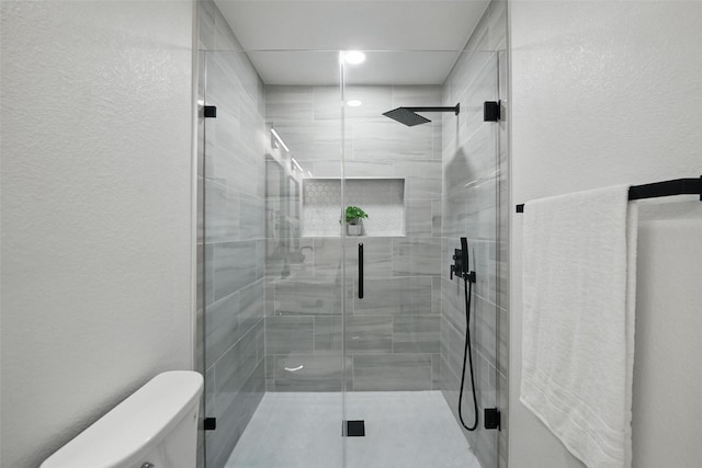 3173 Catamore Ln, Dallas, TX 75229 - bathroom with toilet, a stall shower, a textured wall, and recessed lighting