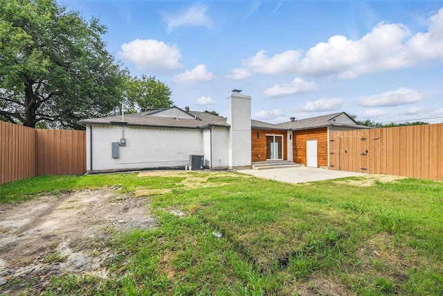 3173 Catamore Ln, Dallas, TX 75229 - rear view of house featuring a chimney, a patio, a gate, and central AC