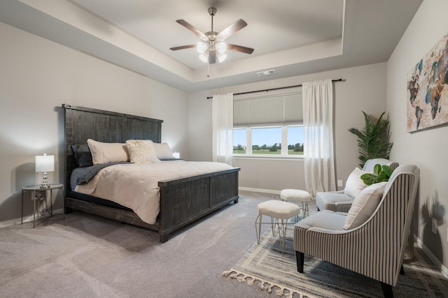 123 Cedar Elm Ln, Nevada, TX 75173 - bedroom with baseboards, a tray ceiling, carpet flooring, and a ceiling fan