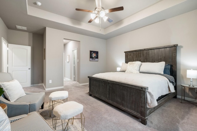 123 Cedar Elm Ln, Nevada, TX 75173 - bedroom with light carpet, baseboards, a raised ceiling, and a ceiling fan