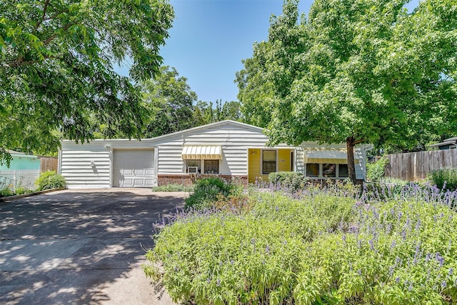 1245 Hodgson St, Fort Worth, TX 76115 - view of front facade with a garage and driveway