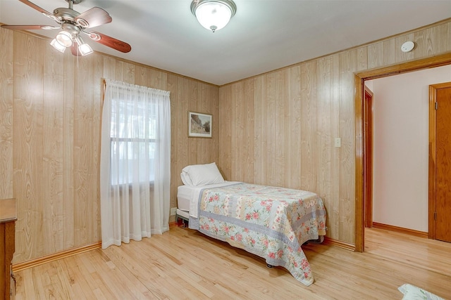 1245 Hodgson St, Fort Worth, TX 76115 - bedroom with wood walls, wood finished floors, and ceiling fan