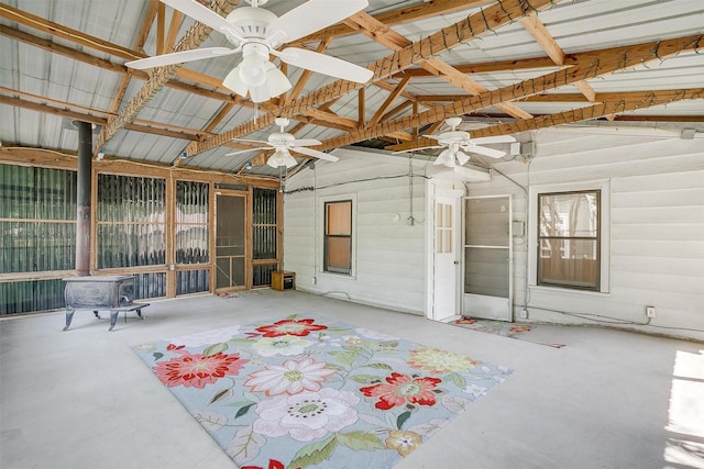 1245 Hodgson St, Fort Worth, TX 76115 - unfurnished sunroom with a ceiling fan, a wood stove, and vaulted ceiling