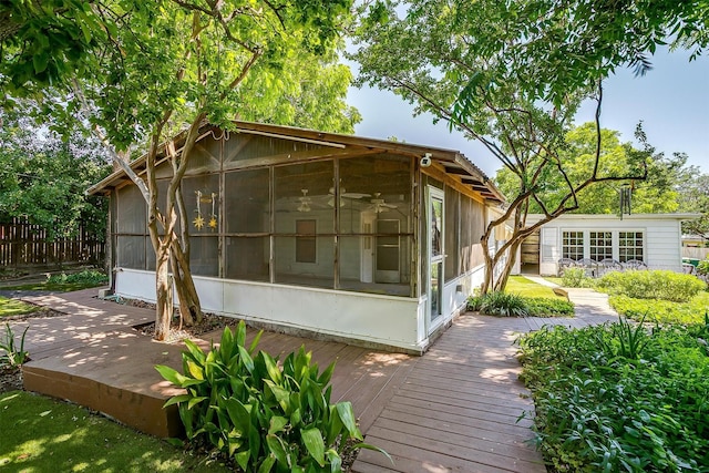 1245 Hodgson St, Fort Worth, TX 76115 - rear view of property featuring a sunroom, a deck, and an outbuilding
