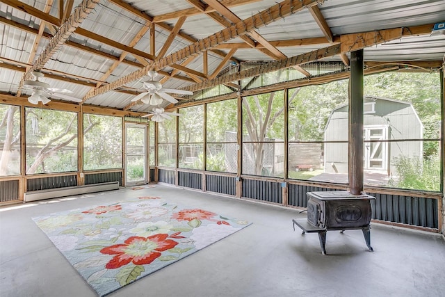 1245 Hodgson St, Fort Worth, TX 76115 - sunroom with a ceiling fan, a baseboard radiator, a wood stove, and lofted ceiling